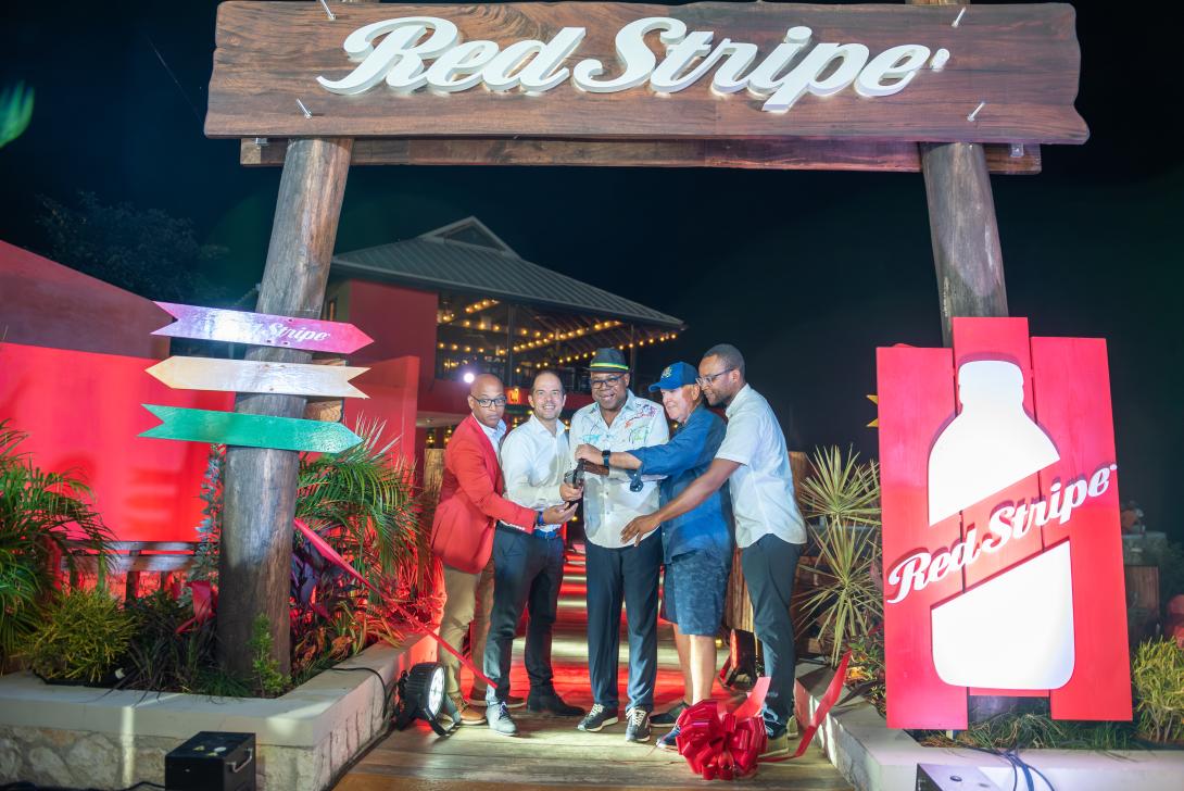 Minister of Tourism, Hon Edmund Bartlett (centre) cuts a red ribbon signalling the grand opening of the Red Stripe Experience at Rick’s Café in Negril, on Saturday, January 18, 2025. He is flanked by (from left) Head of Commerce, Red Stripe, Sean Wallace; Managing Director of Red Stripe, Daaf van Tilburg; CEO of Rick’s Cafe, Steve Ellman and Member of Parliament, Westmoreland Western, Morland Wilson.